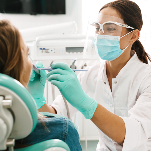 Female dentist working on patient